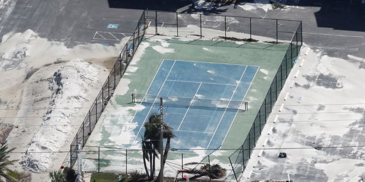 Broken Fences Surrounding A Tennis Court In Clearwater