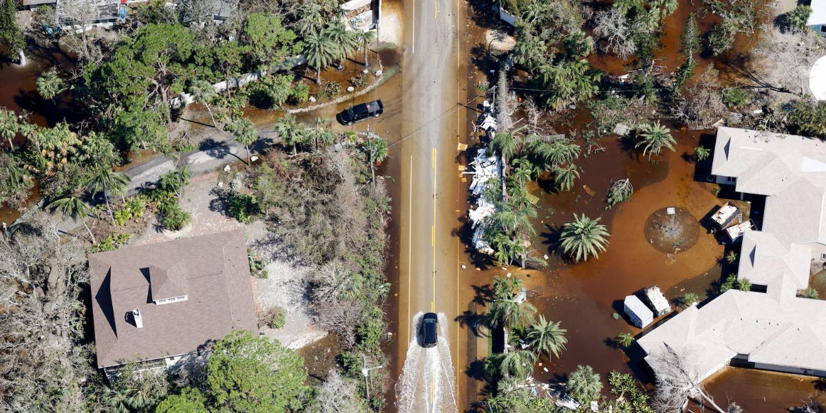 Car Driving Through A Flooded Street