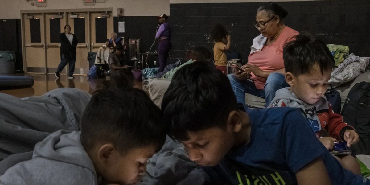 Families Take Shelter Inside A School Sports Gymnasium