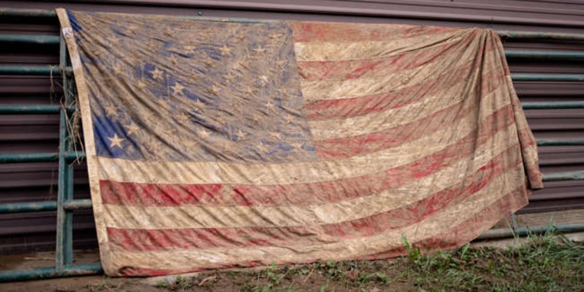 American Flag Covered In Dust And Mud