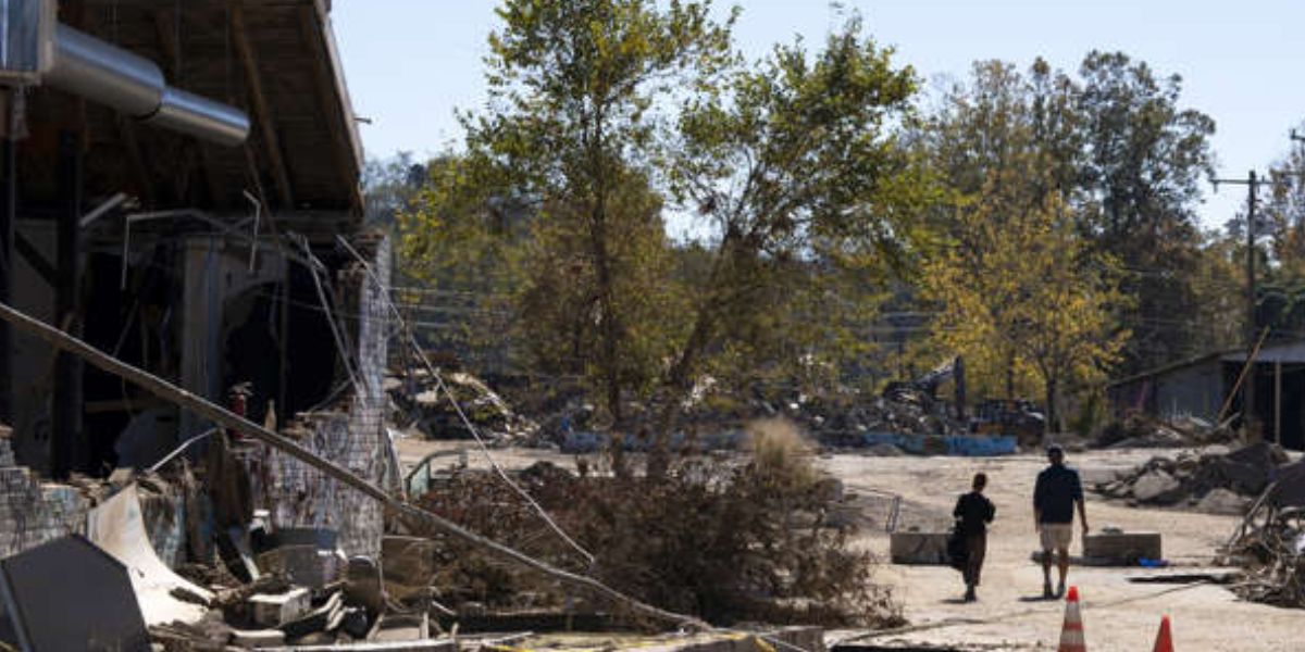 Couple Walks Alongside A Collapsed Wall