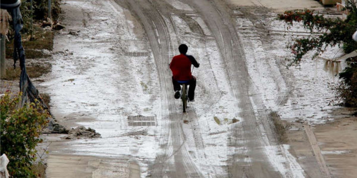 Man Rides His Bike Through The Muddy Road