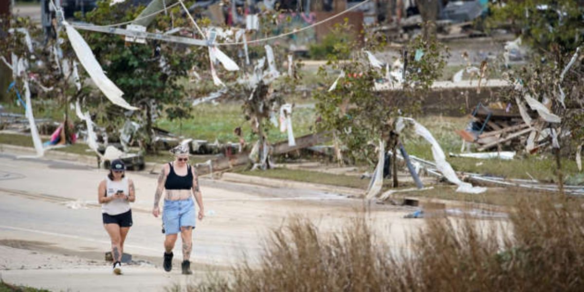 Pedestrians Walk Alongside The Debris