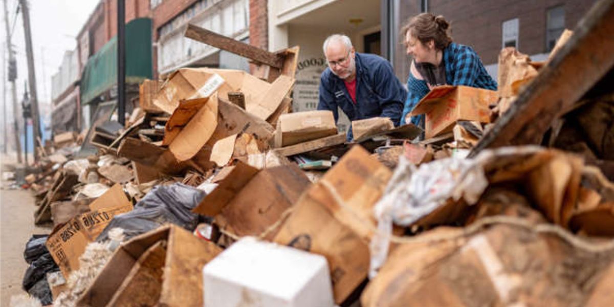 Two Residents Sorting Out The Debris