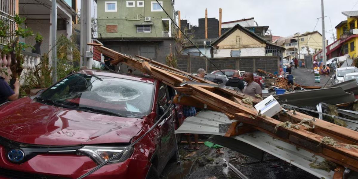 People Standing Near A Damaged Car In Mayotte, France